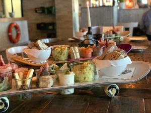 a tray of food on a table with sandwiches and dips at Bretterbude Heiligenhafen in Heiligenhafen