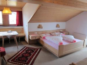 a bedroom with a bed and a table in a room at Gästehaus Valentina in Mayrhofen +6 photos