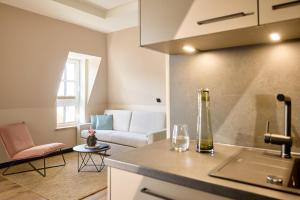 a kitchen and a living room with a couch at Gezeiten Suites Büsum - Neueröffnung in Büsum +112 photos