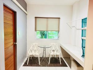 a dining room with two chairs and a table at Sino @ Thungsong in Thung Song