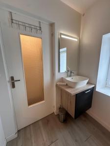 a bathroom with a sink and a mirror at L'Essentiel de Paray in Paray-le-Monial