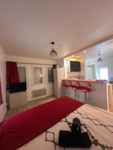 a bedroom with a bed with a red blanket on it at L'Essentiel de Paray in Paray-le-Monial