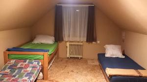 a room with two bunk beds and a window at Casa Wylak Winery in Uileacu de Criş +2 photos