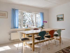a dining room with a wooden table and chairs at Spacious Villa in Lillehammer in Lillehammer