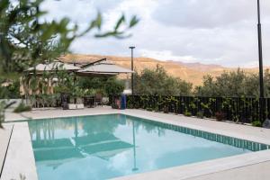 a swimming pool with a view of the mountains at Pauz Hotel in Himare