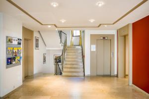 a hallway with a staircase in a building at Garner Hotel Stuttgart City Centre by IHG in Stuttgart