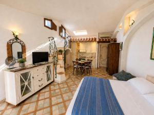 a hotel room with a bed and a living room at Dolce Vita Boutique Hotel in Porto Cervo