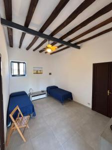 a room with a bed and a table and a ceiling at Casa Cristian Stromboli in Stromboli