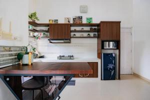a room with a desk and a table in a room at The Lavana Signature Villa Herrera Puncak in Puncak