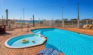 a swimming pool with a toy in the middle at Scottburgh Peacehaven Holiday Flat 202 in Scottburgh