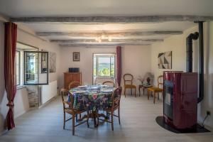 a dining room with a table and chairs at Gîte Les Sapins Douglas in Sansac-Veinazés