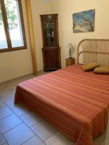 a bedroom with a large bed and a wooden cabinet at Vautrain in Artignosc-sur-Verdon