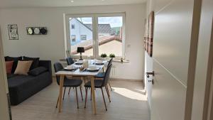 a living room with a table and chairs and a couch at Residenz Agnes in Beckingen