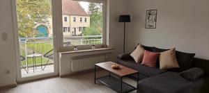 a living room with a couch and a large window at Residenz Agnes in Beckingen