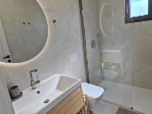 a bathroom with a sink and a shower and a toilet at Mareya Premium Stay in Poreč +16 photos