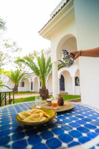 a table with a plate of food on it at Maison d'hôtes Villa Latifa Essaouira in Essaouira