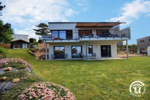 a large house with a balcony on a yard at Brise marine in Trébeurden
