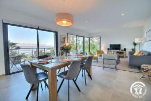 a dining room and living room with a table and chairs at Brise marine in Trébeurden