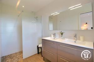 a bathroom with a sink and a mirror at Brise marine in Trébeurden +44 photos