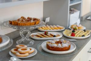 a buffet filled with different types of pastries and desserts at Hotel Virginia in Marina di Massa