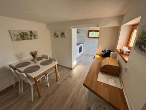 a kitchen and dining room with a table and chairs at Paloznak Panoráma in Paloznak
