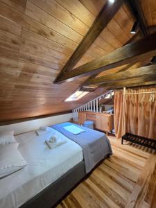 a large bed in a room with wooden ceilings at Elia City House in Kavála +71 photos