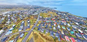 an aerial view of a parking lot next to the ocean at Guesthouse Leon - Historic Home Near City Center with Free Parking in Tórshavn