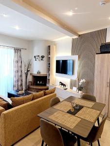 a living room with a couch and a table at Villa Red Porto Cheli in Porto Heli