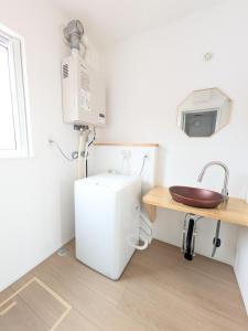 a small bathroom with a sink and a toilet at cottage hapo in Higashikagura