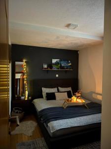 a bedroom with a large bed with a tv on the wall at Vikendica Šehić in Zavidovići +26 photos