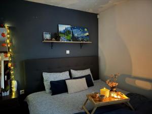 a bedroom with a bed with a table on it at Vikendica Šehić in Zavidovići