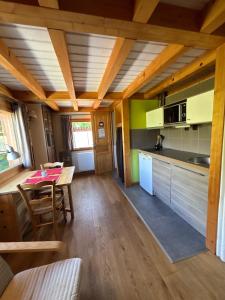 a kitchen and dining room with a table and chairs at Omazot au calme dans verdure in Aix-les-Bains +7 photos