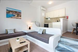 a small room with a bed and a table at Balaris Apartments in Kassiopi