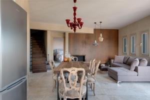a dining room and living room with a table and chairs at Amaranthine Villa in Imerovigli