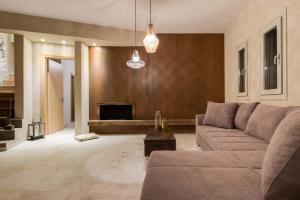 a living room with a couch and a fireplace at Amaranthine Villa in Imerovigli