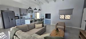 a living room with a couch and a table at Sage & Salt in St. Helena Bay
