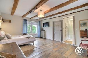 a bedroom with a bed and a table at Le clos des sittelles in Theix
