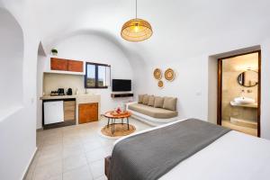 a bedroom with a bed and a living room at Santorini Rooftop Hot Tub Suite with Panoramic Views in Akrotiri