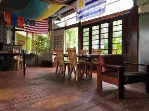 a dining room with a table and chairs and a flag at Cross Roads BackPackers Entebbe in Entebbe