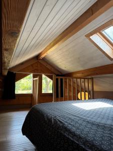 a bedroom with a bed with a wooden ceiling at Omazot au calme dans verdure in Aix-les-Bains