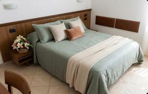 a bedroom with a large bed with pillows on it at B&B da Giorgia in Crodo