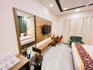 a hotel room with a bed and a tv at Southern Stays in New Delhi