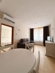 a living room with a table and a couch at Aparthotel Bahia Pinosol in Jávea
