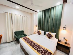 a bedroom with a bed and a green chair at Southern Stays in New Delhi