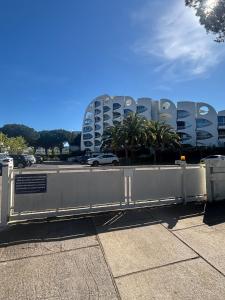 a gate in front of a parking lot with a building at Studio cabine parking 4 pers plage à proximité in La Grande Motte +17 photos