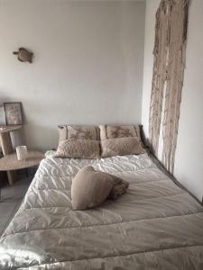 a bed in a bedroom with a pillow on it at Studio cabine parking 4 pers plage à proximité in La Grande Motte