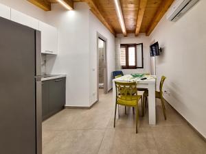 a kitchen and dining room with a table and chairs at La Casa Sotto il Campanile in Sciacca