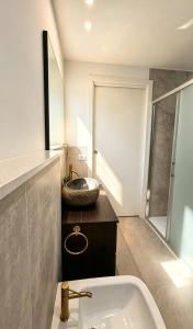 a bathroom with a sink and a bath tub at Casa LIAM & Casa ISABEL in Chioggia