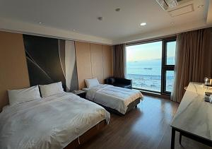 a hotel room with two beds and a large window at Wolmido Premiers Hotel in Incheon +42 photos