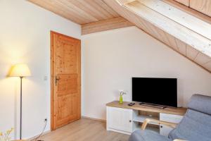 a living room with a tv and a couch at Fewo Enzian in Breitenberg
